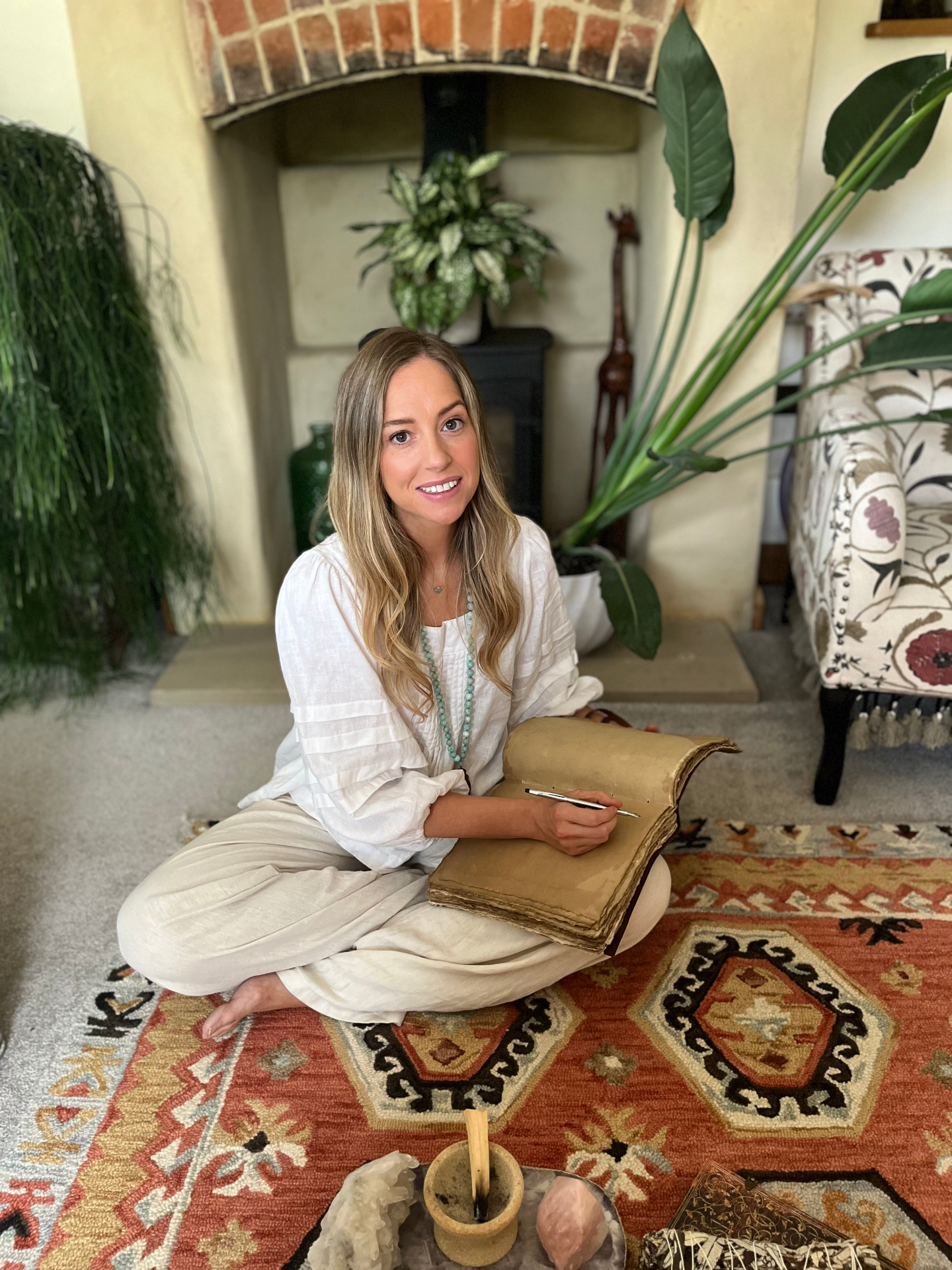Kate Leach smiling, writing in an old journal